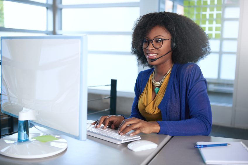 Portrait of a smiling customer service representative with an afro